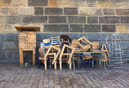 Furniture removal team collecting bulky items in a London residential street
