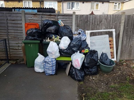 London recycling and rubbish collection with bins on a city street